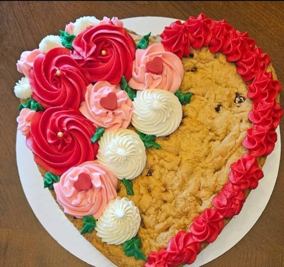 Heart-shaped cookie cake with piped buttercream roses